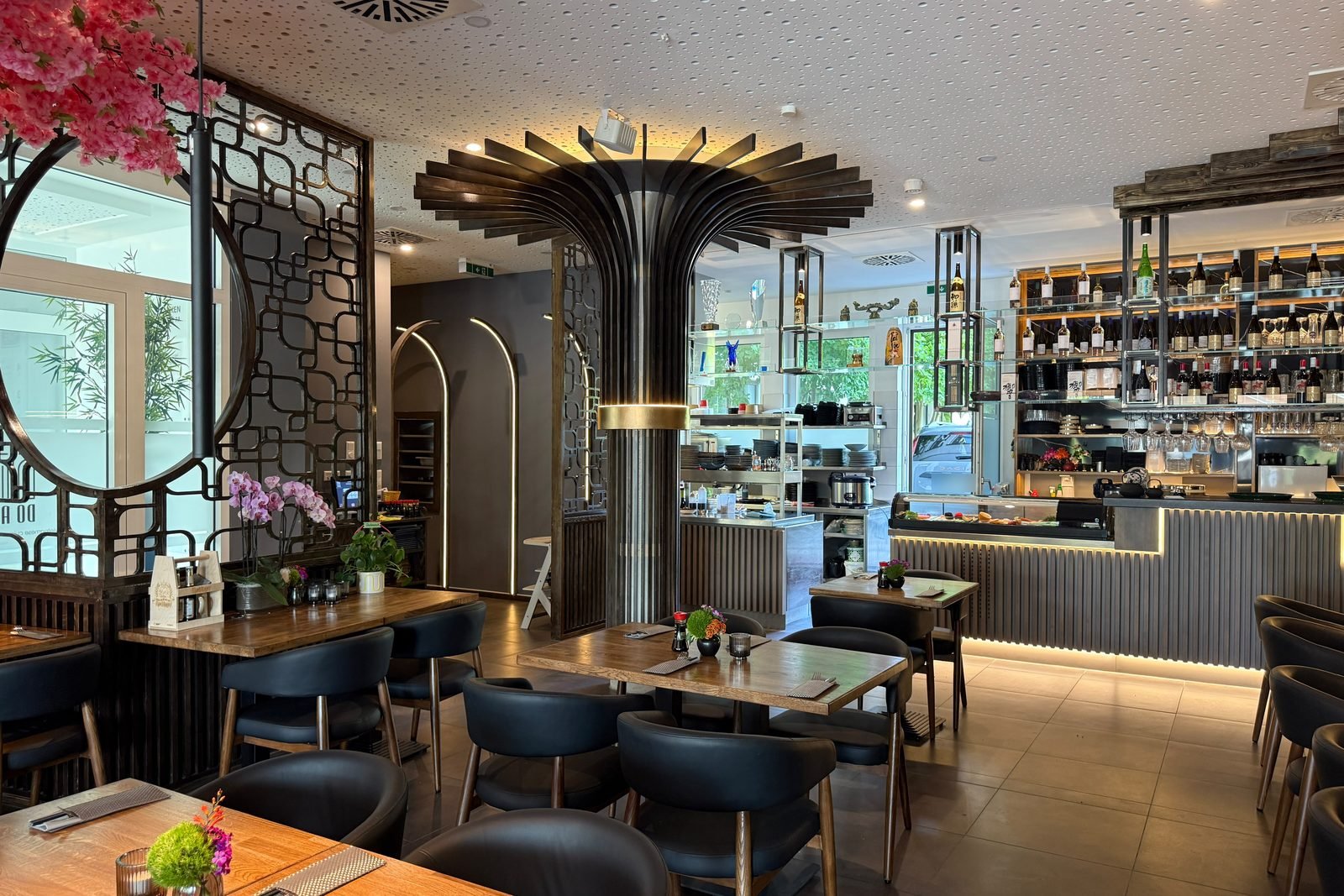 Gastraum von Do An Regensburg mit Fächersäule, Weinregal und Sushi-Theke